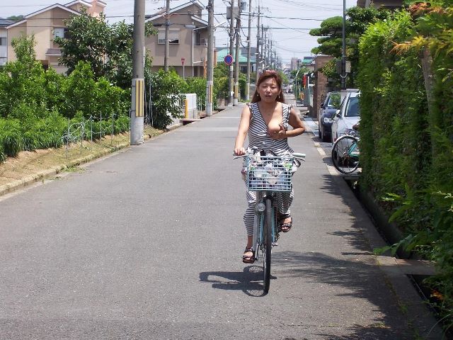 片乳をポロリせながら自転車に乗ってる変態熟女！